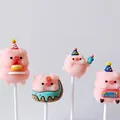 Macro view of four cute pink soft rubber pig cake toppers with birthday party hats - Soft Rubber Pig 4 Piece Set