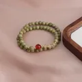 Double-loop beaded bracelet featuring avocado green Alashan stones and a red carnelian accent - Alashan Avocado Red Agate Double Layer Bracelet