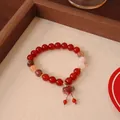 Close-up detail of a natural red agate beaded bracelet featuring a gourd pendant - Natural Red Agate Red Flower Gourd Style