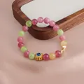 Detailansicht eines Armbands mit bunten Wassermelonen-Turmalin-Perlen und Lotus-Anhänger - Lotus Stil / Frucht-Turmalin Lotus Stil
