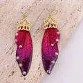 Macro view of vintage butterfly wing earrings with reddish purple gradient and sparkling glitter - Gold Hook / Dreamy Rose Red