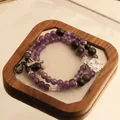 Natural amethyst and obsidian beaded bracelet with a square gemstone on a wooden tray - Cross Pendant Double Wrap Style / Purple and Black