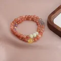 Close-up of a double-layer beaded bracelet featuring strawberry quartz and sunstone - Sunstone Double Layer Bracelet