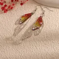 Detailed macro shot of elegant cicada wing drop earrings with colorful gradient and rhinestones. - Silver Frame / Orange Yellow Rhinestone