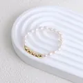 Close-up of minimalist freshwater pearl bracelet with five golden oval beads on display - Bracelet (Style 2)