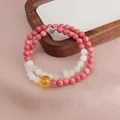 Macro detail view of a double-strand beaded bracelet with pink stones and citrine - Double Wrap Bracelet / Rhodonite Green Jadeite Running Ring Bracelet