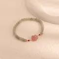 Close-up of elegant moonstone beaded bracelet featuring a pink flower quartz charm - Agate Flower Charm Style