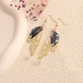 Detailed view of bohemian gold cicada wing earrings with colorful resin and crystal accents - Gold Frame / Blue and Purple
