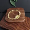 Close-up of natural yellow crystal beaded bracelet with carved nine-tailed fox charm - Floral Plate (5633710176779) / Single Loop