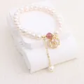 Macro view of natural freshwater pearl bracelet featuring a zircon flower pendant - Zircon Petal Style