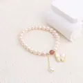 Close-up of elegant freshwater pearl bracelet with butterfly shell pendant on white background - Butterfly Pendant