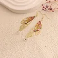 Elegant gold-tone handmade cicada wing drop earrings with sparkling rhinestones and clear beads - Gold Frame / Light Orange