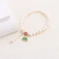 Close-up of a natural freshwater pearl bracelet with a green fan-shaped pendant - Green Fan-shaped