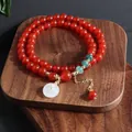 Vista detallada de cuentas de ágata roja natural con jadeíta azul y colgante de jade - Pulsera Ágata Roja Ping An Kou