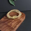 Detailed view of natural yellow citrine bracelet with a carved pixiu charm on wood - Pixiu (5633710176784)