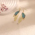 Elegant golden butterfly wing drop earrings with teal iridescent finish and small crystals - Gold Frame / New Blue