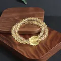 Close-up detail of natural citrine double-strand bracelet with carved flower pendant - Nine-Tailed Fox (5633710176785)
