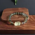 Original green phantom crystal bracelet with lemon yellow Pixiu carving on wooden display - Pi Xiu Style 1 / Green & Yellow