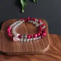 Natural stone bracelet featuring rose red tiger eye and clear quartz beads on wood. - Rose Red Tiger Eye Moonstone Double Layer Bracelet