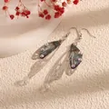 Elegant silver long drop earrings with iridescent cicada wings and crystal accents - Silver Frame / Light Blue Landscape