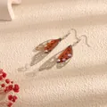 Elegant cicada wing style long tassel earrings with shimmering rhinestone accents in brown finish - Silver Frame / Red