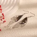 Elegant silver-toned cicada wing earrings with translucent dark resin and iridescent crystals - Silver Frame / Off Black