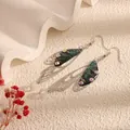 Elegant long cicada wing drop earrings featuring iridescent crystals and silver hooks - Silver Frame / Teal