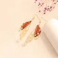 Elegant butterfly wing drop earrings with orange cicada pattern and sparkly crystals - Gold Frame / Amber