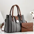 Detailed view of 2-piece bag set with woven pattern handbag and matching brown wallet. - 28*13*21cm / Black