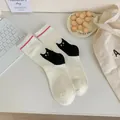 Japanese style women's cream crew socks with cute black cat illustration - White Cat with Crystals / White