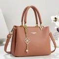 Detail showing elegant dusty rose leather texture and decorative gold flower pearl charm - 26*11*18 / Pink