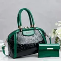 Close-up of a two-piece handbag set with embossed floral patterns and a green glossy finish. - 29*13*22 / Green