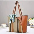 Detailed view of a large patchwork tote bag with striped canvas and decorative silk scarf - 32x11x28cm / Earthy Yellow