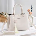 Elegant cream-colored faux leather handbag with decorative tassel and adjustable crossbody strap - 28*12*19 / Off-white Style 2