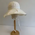 Elegant cream-colored wide brim sun bucket hat with adjustable chin straps for women - 56-58cm / Beige