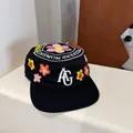 Black flat-top pillbox cap with colorful floral embroidery and white AG letter design - 56-58cm / Black