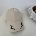 Beige baseball cap with unique black embroidered lightning bolts on the brim. - 56-59cm / Adjustable / Beige