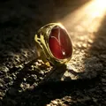 Close-up of a vintage gold wide ring with a large red agate cabochon under sunlight - Adjustable Open / Red Agate Style