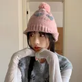 Stylish pink knit beanie featuring grey heart patterns and a plush pom-pom for winter - 56-60cm / Pink