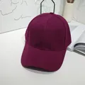 Detail view of a classic burgundy solid color baseball cap in a minimalist setting - 55-60cm / Burgundy