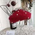Elegant close-up of red wool beret with pearl accents and delicate black mesh veil - 54-58cm / Pearl Mesh Style / Red