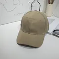 Minimalist khaki cotton baseball cap displayed on a white aesthetic desk setup. - 55-60cm / Khaki