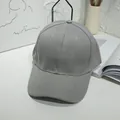 A detailed view of a plain grey solid color baseball cap in a minimalist lifestyle setting - 55-60cm / Gray
