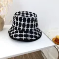 Retro black and white checkered knit bucket hat on a minimalist white table - 55-58cm / Black