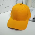 Close-up of a vibrant yellow plain baseball cap with visible twill fabric texture - 55-60cm / Lemon Yellow
