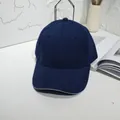 Detailed close-up view of a classic navy blue plain cotton baseball cap with curved brim - 55-60cm / Navy Blue with Contrast Trim