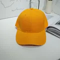 Detailed front view of a vibrant yellow cotton twill baseball cap on a minimalist desk. - 55-60cm / Lemon Yellow with Contrast Trim