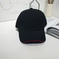 Detail view of a classic black baseball cap featuring a stylish red trim on the curved brim - 55-60cm / Black and Red Contrast Trim