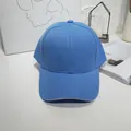 Detail view of a solid sky blue unisex baseball cap on a clean white studio background. - 55-60cm / Sky Blue with Contrast Trim