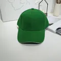 Classic green baseball cap shown from front view on a minimalist white table surface - 55-60cm / Green with Contrast Trim